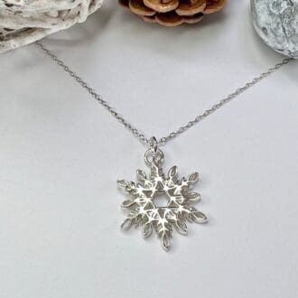 Silver snowflake necklace handmade using recycled fine silver