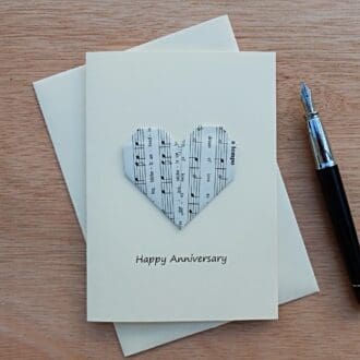 Origami-music-paper-heart-on-cream-card-with-Happy-Anniversary-written-on-it