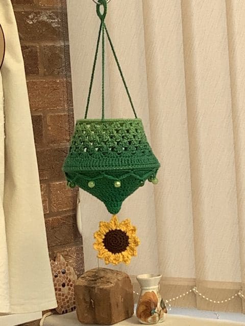 Crochet lantern with a crochet sunflower.