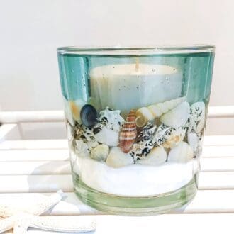 Blue Sea Ocean Soy and Gel Wax scented candle on a bleached white wooden seat
