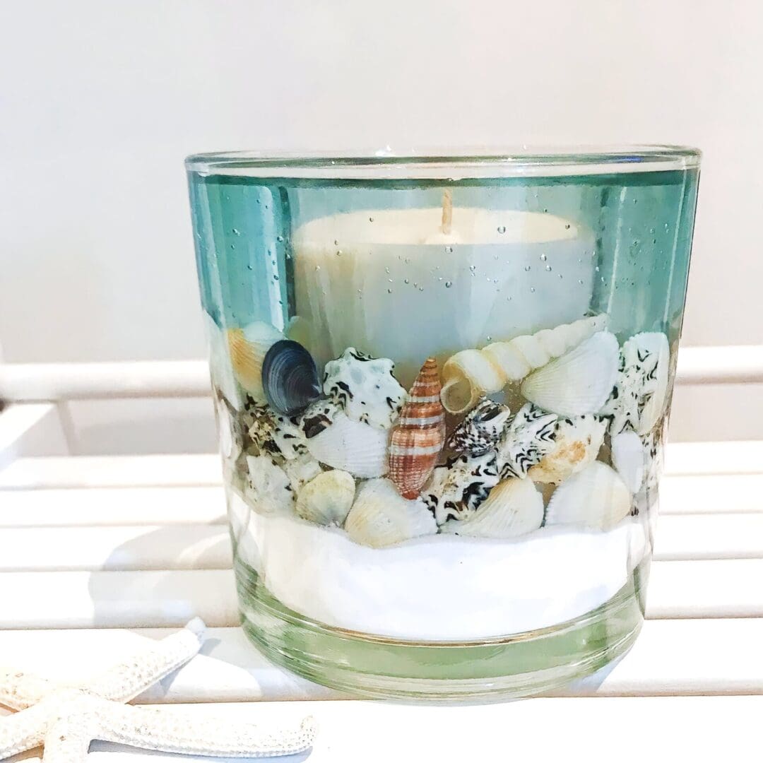 Blue Sea Ocean Soy and Gel Wax scented candle on a bleached white wooden seat