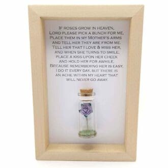 small glass bottle containing a paper rose in a wood frame with a personalised mother memorial quote