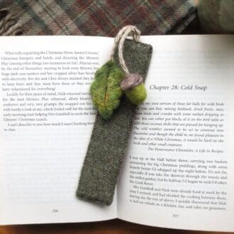 Needle felted wool acorn and oak leaf attached with jute cord to a tweed bookmark
