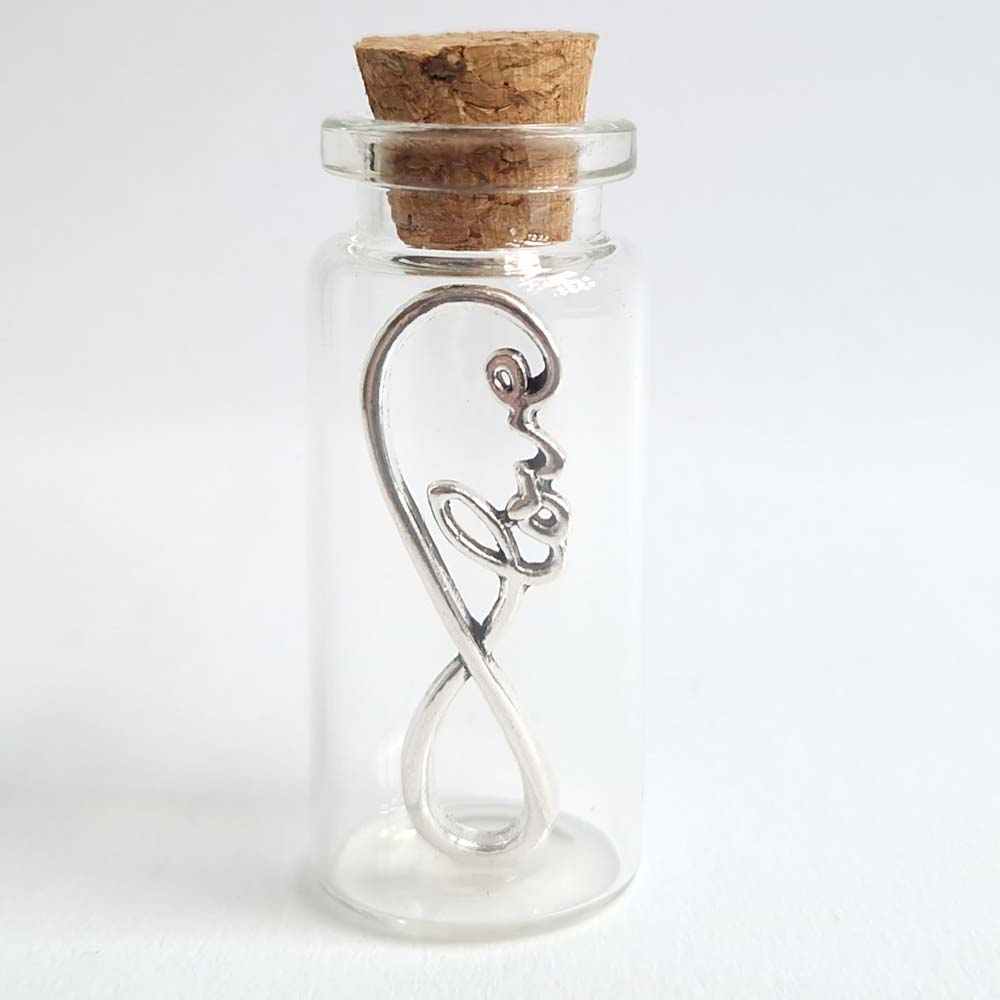 Miniature glass bottle containing an infinity charm