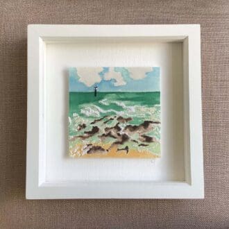 a painted and hand embroidered coastal scene