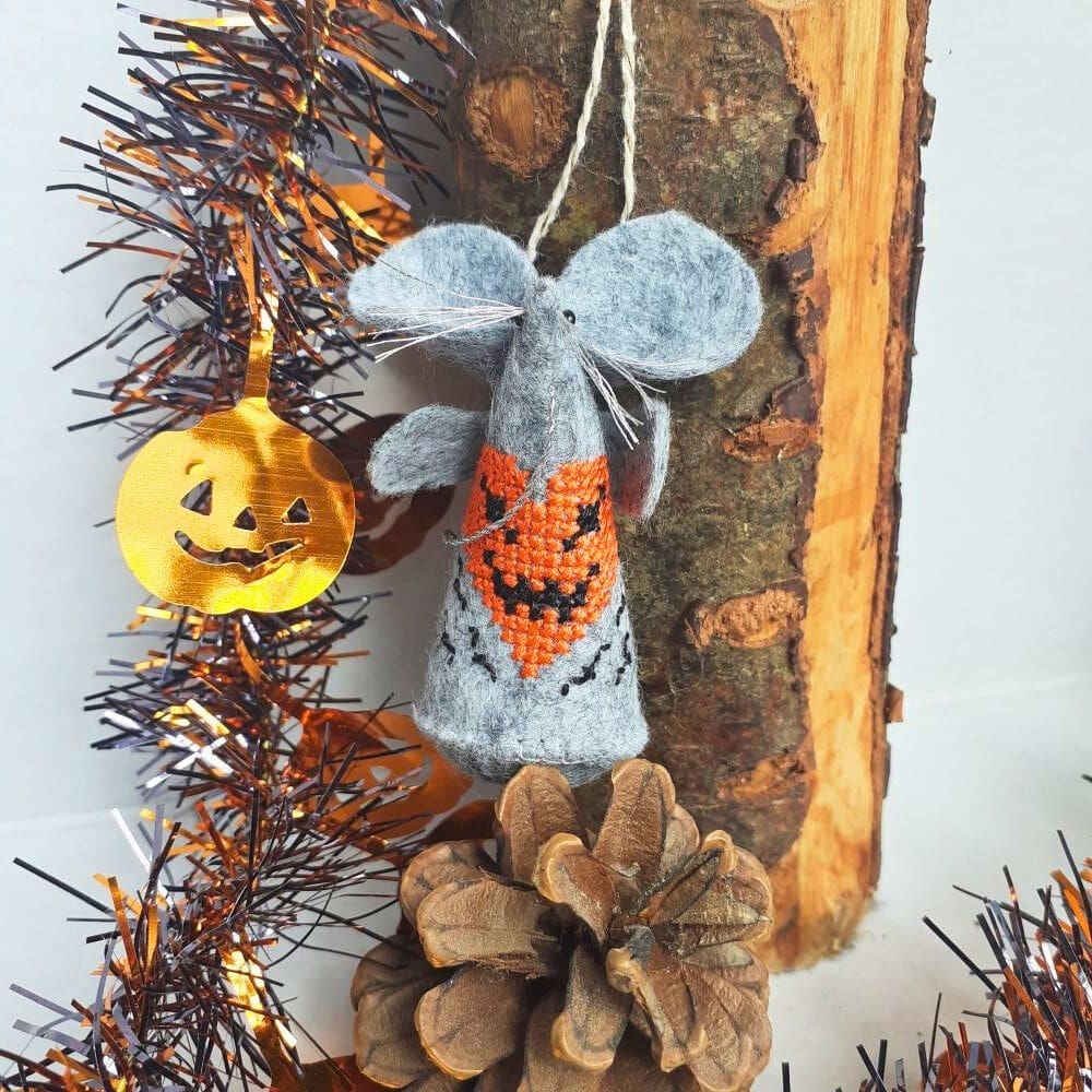 Hand stitched felt mouse with a cross stitch Halloween pumpkin design