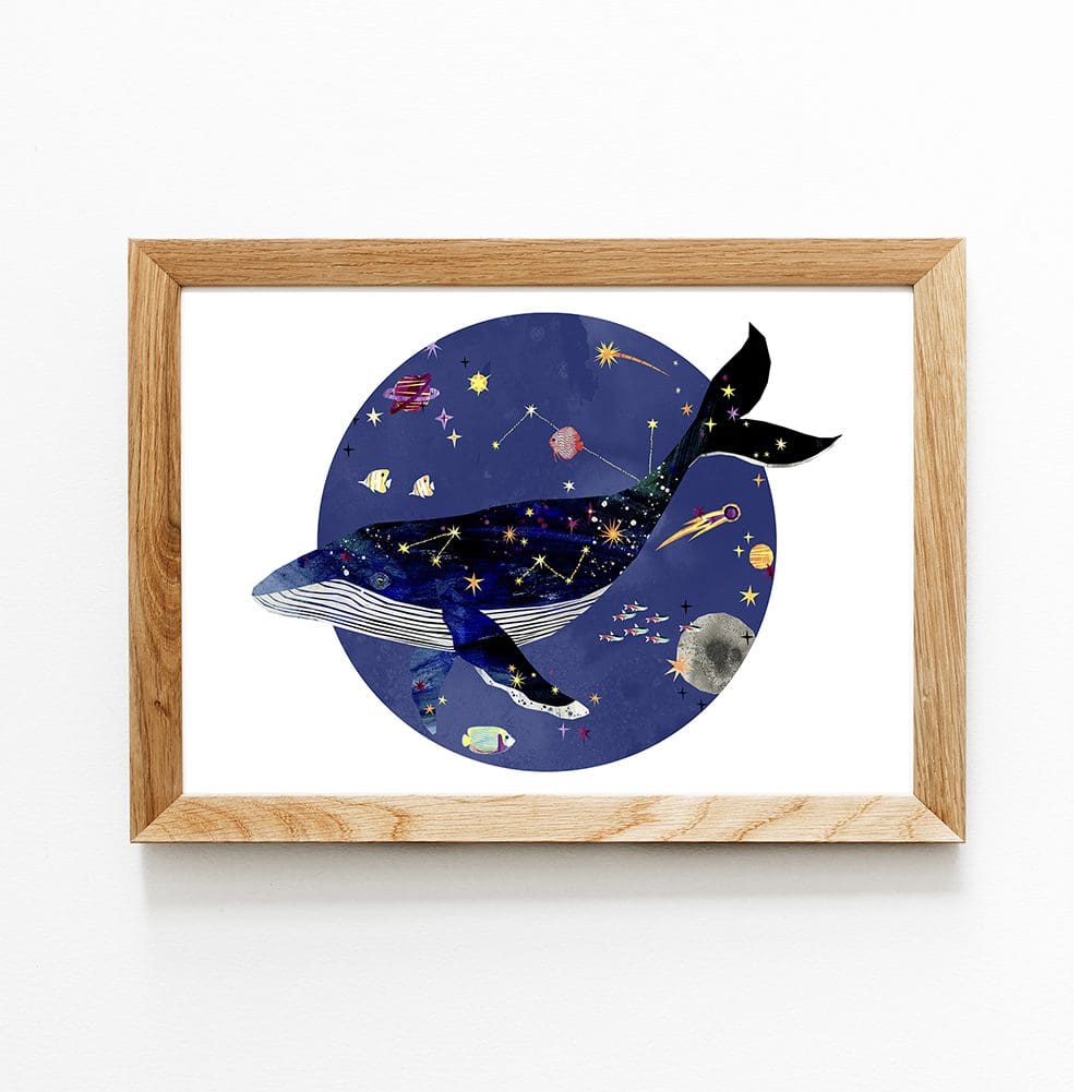 In the centre of the image is a framed art print. The print features a digital illustration of a whale with stars and constellations across it's back, surrounded by planets, stars and other, smaller fish.