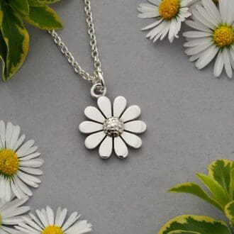 Flat profile sterling silver daisy with ten petals and a dimpled dome centre on a mini belcher chain