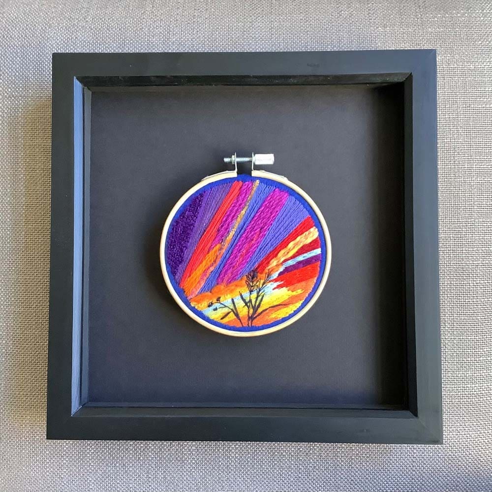 framed dramatic hand embroidery of the setting sun