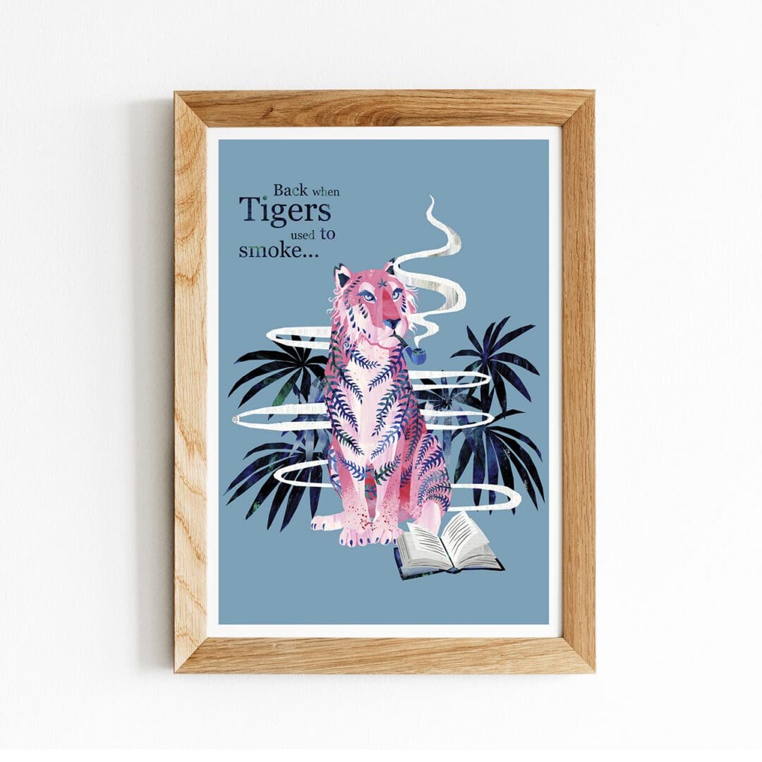 In the centre of the image is a framed art print. The print features a digital illustration of a sitting, pink tiger, smoking a pipe on a blue background. Words to the side of the tiger read 'back when tigers used to smoke'.