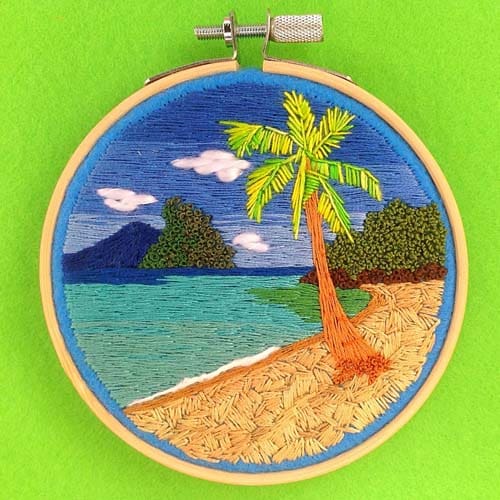 a hand embroidered beach scene