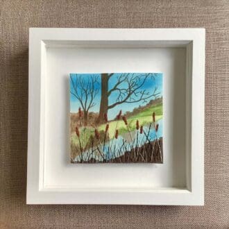 framed embroidery of a pond surrounded by rushes