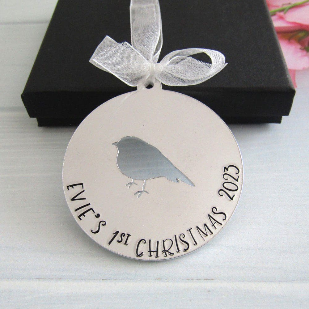 personalised aluminium christmas tree decoration with the words baby's 1st christmas handstamped on it