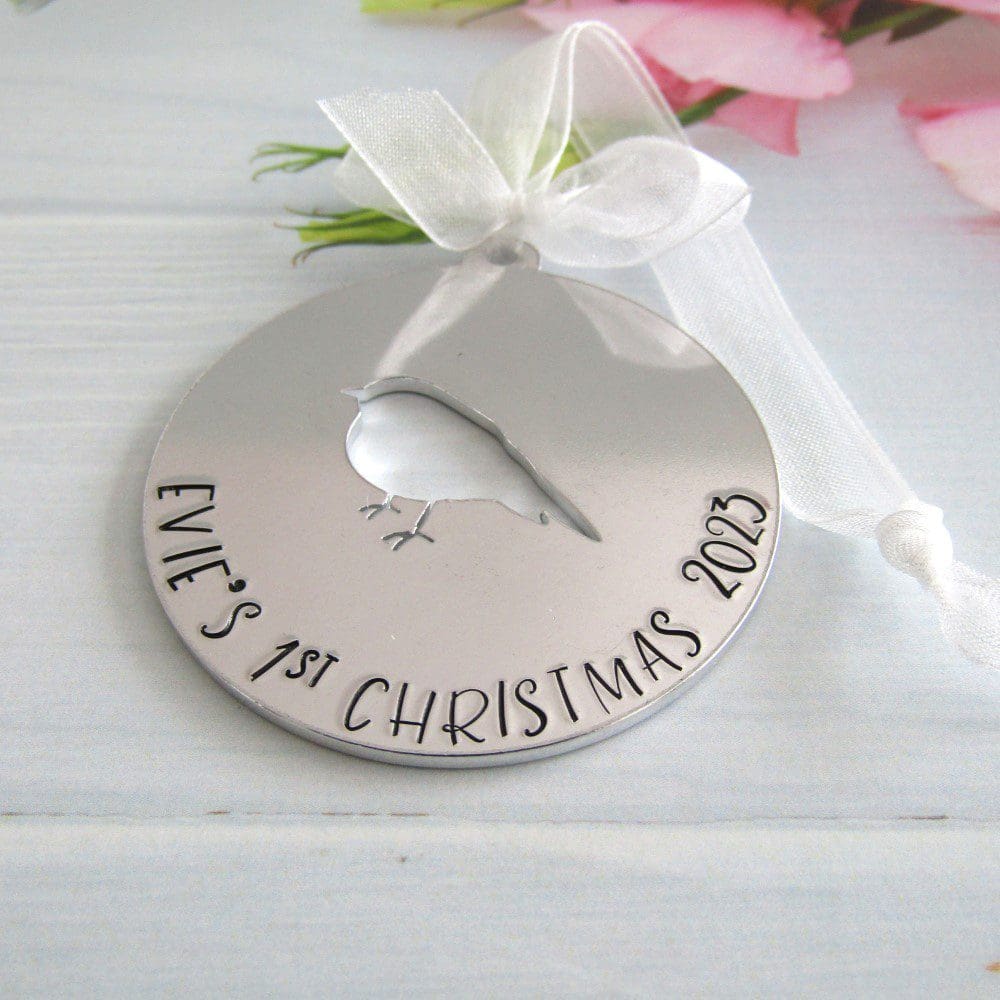 personalised aluminium christmas tree decoration with the words baby's 1st christmas handstamped on it