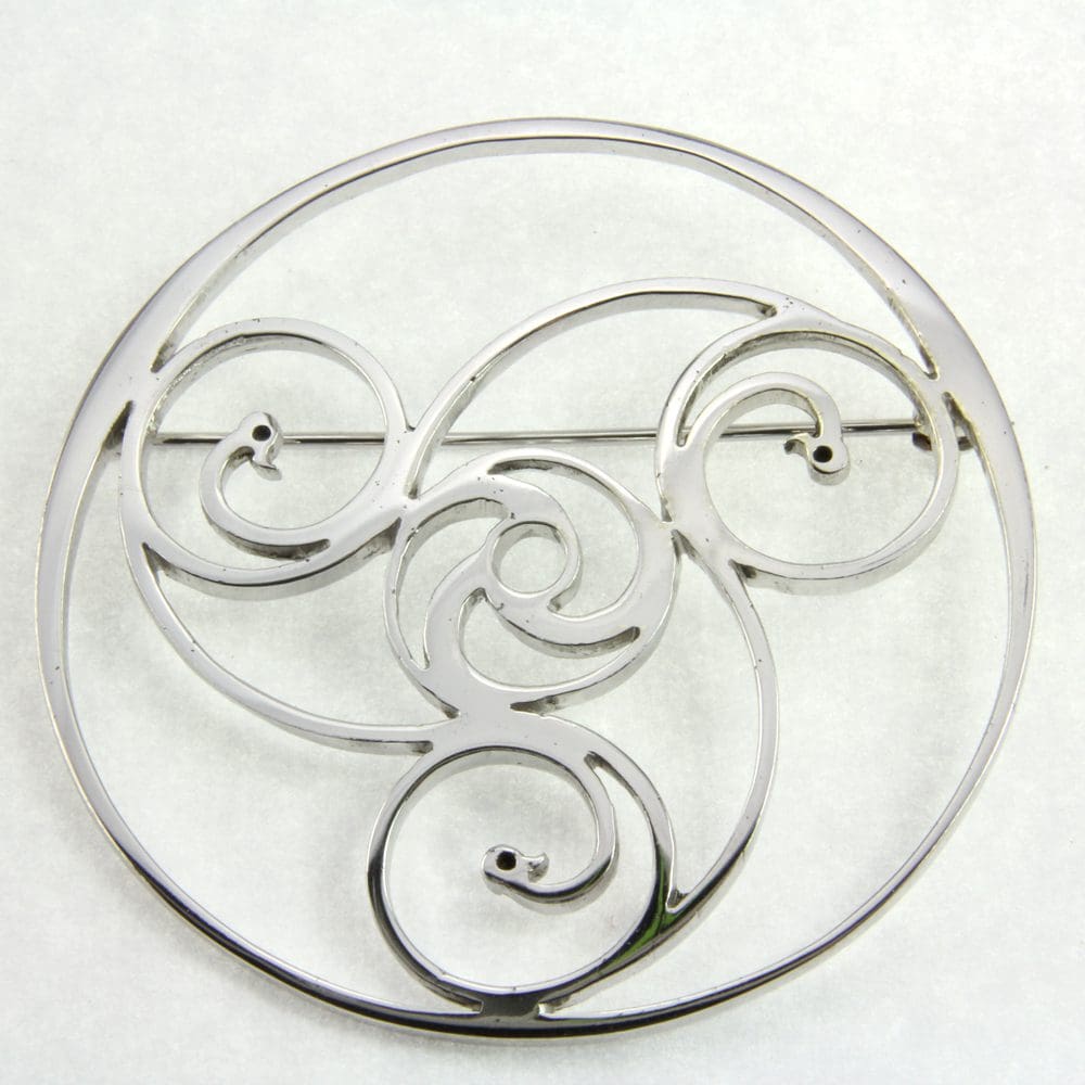 Round silver brooch, celtic design, historic significance, large circle with three more circles inside with the end a swan head.
