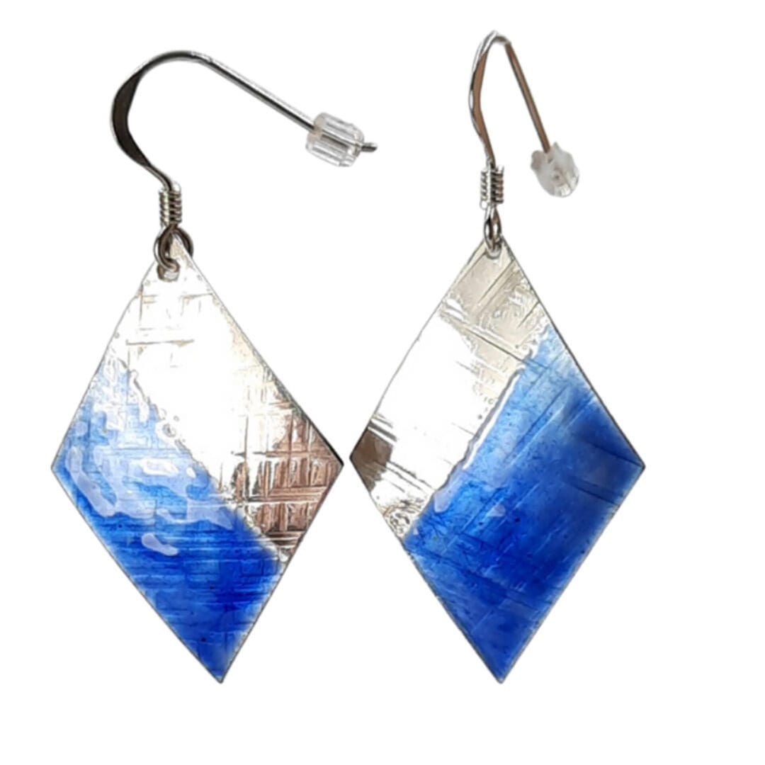 electric blue diamond shape earrings, half of the diamond shape is enamelled. The earrings are dangling earrings with a sterling silver hook