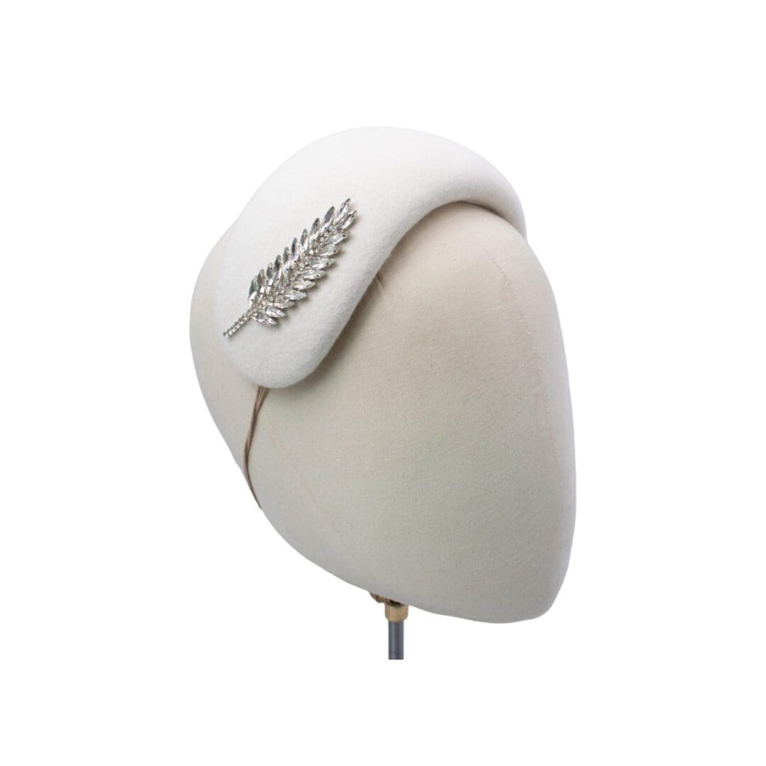 ivory coloured wool felt bandeau style hat with diamante feather trim
