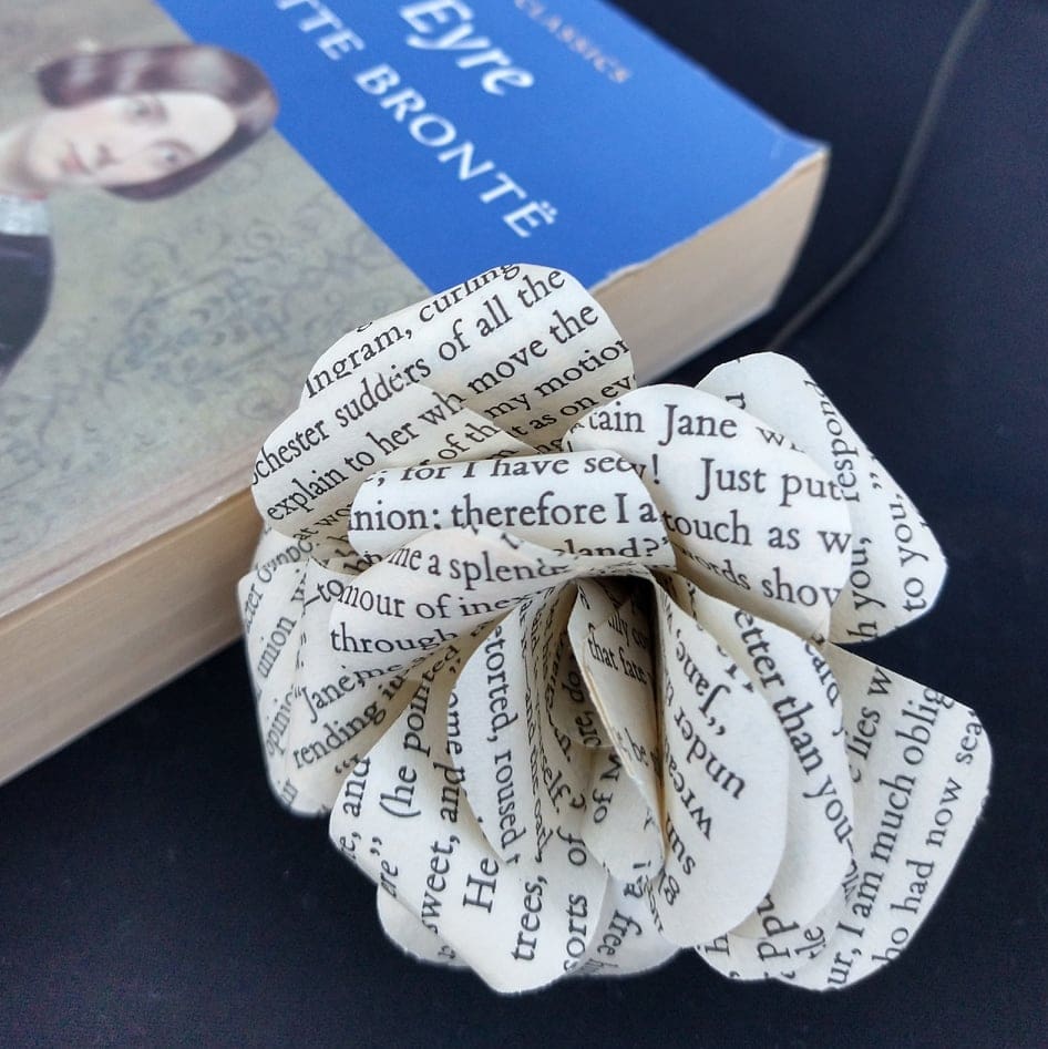 Close up of Paper rose made from pages from Jane Eyre, resting on the novel
