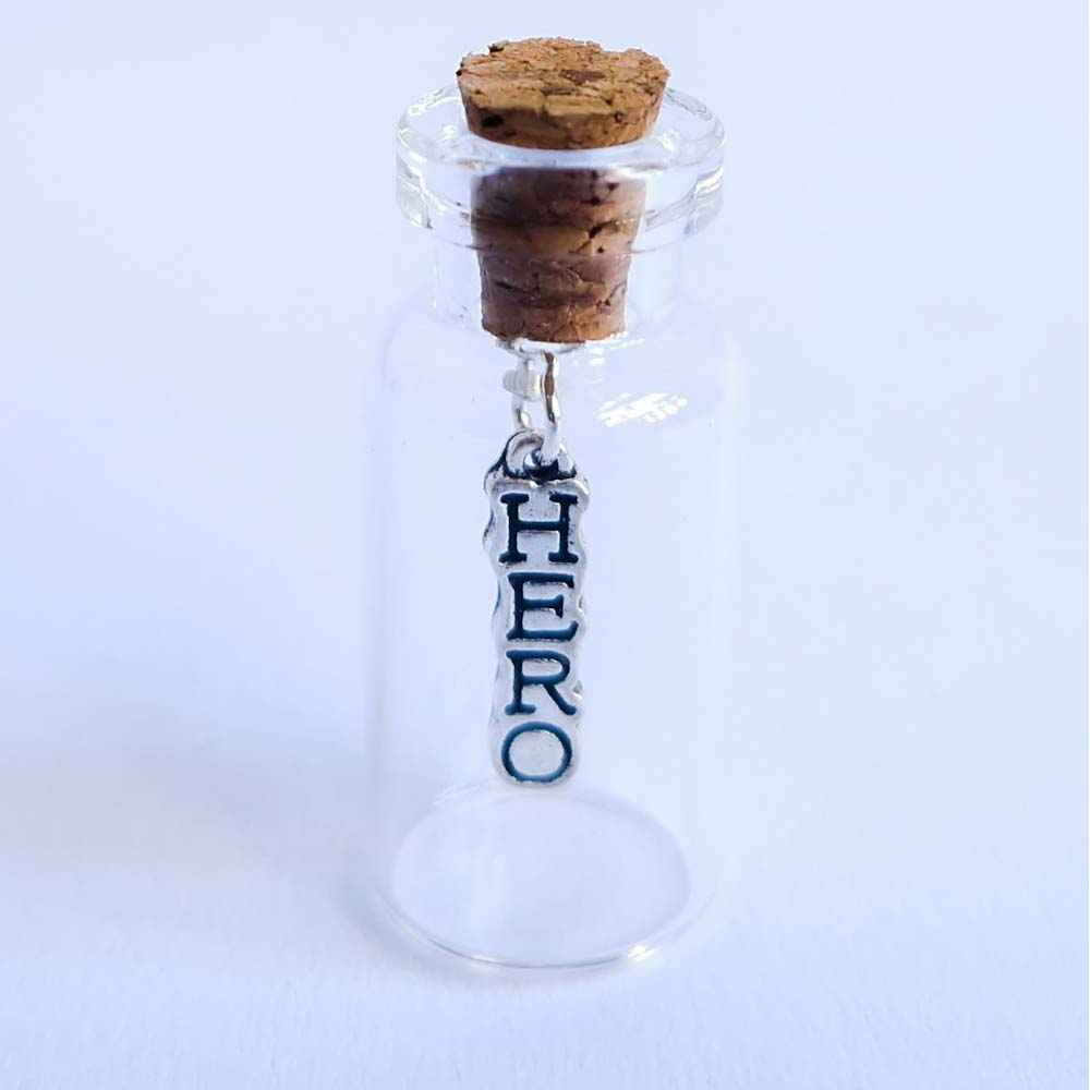 miniature glass bottle gift with a small silver hero charm inside, designed by under the blossom tree
