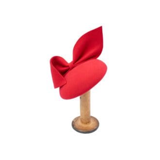 red felt button cocktail hat with large bow trim on white background