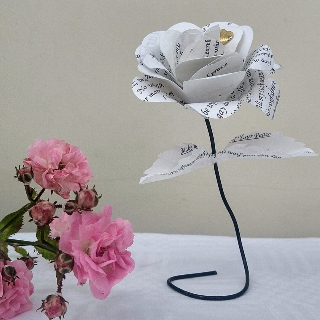 Paper rose standing upright, made from upcycled wedding stationery