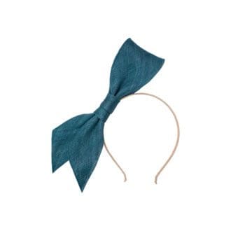 teal blue large bow mounted on a thin headband on white background