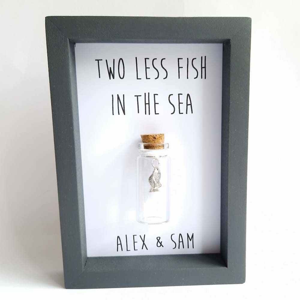 grey frame with a miniature glass bottle containing 2 fish, wedding gift