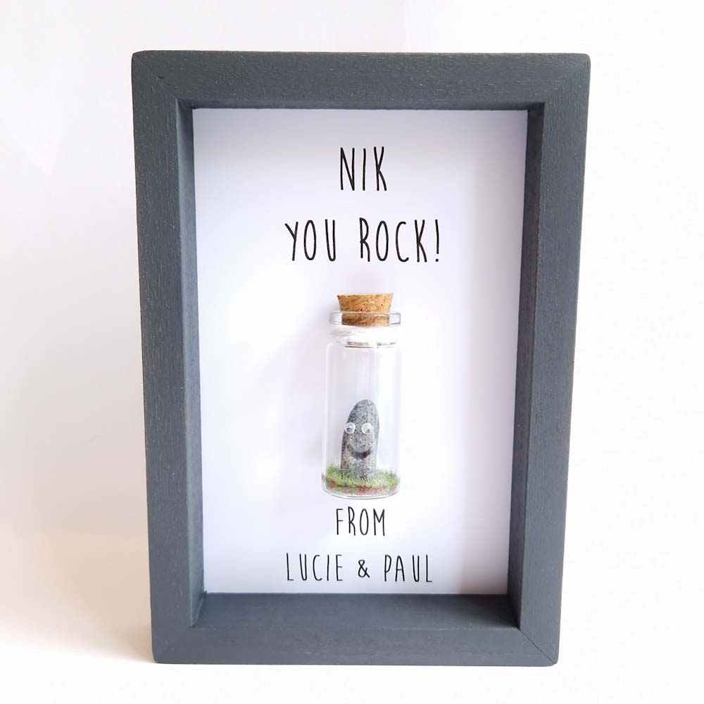 Small frame with a miniature glass bottle