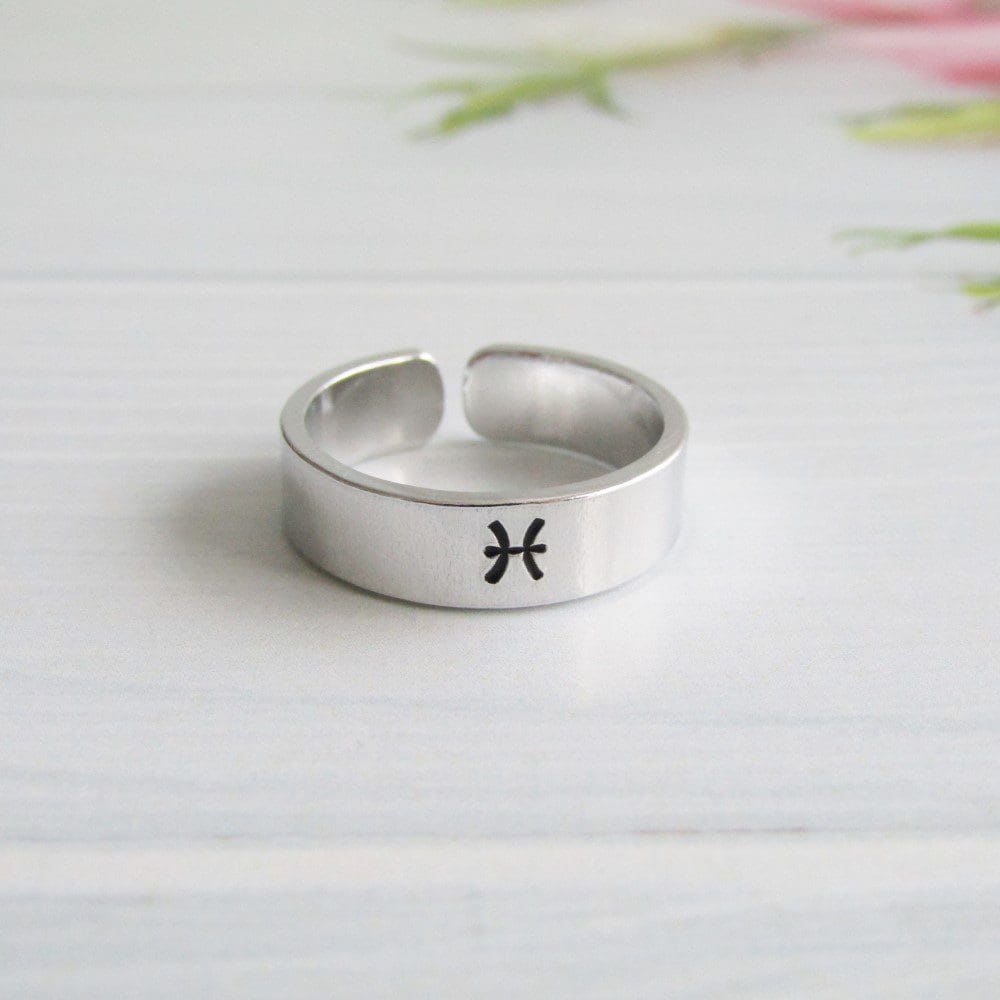 6mm wide aluminium cuff ring with a hand-stamped zodiac symbol on the front