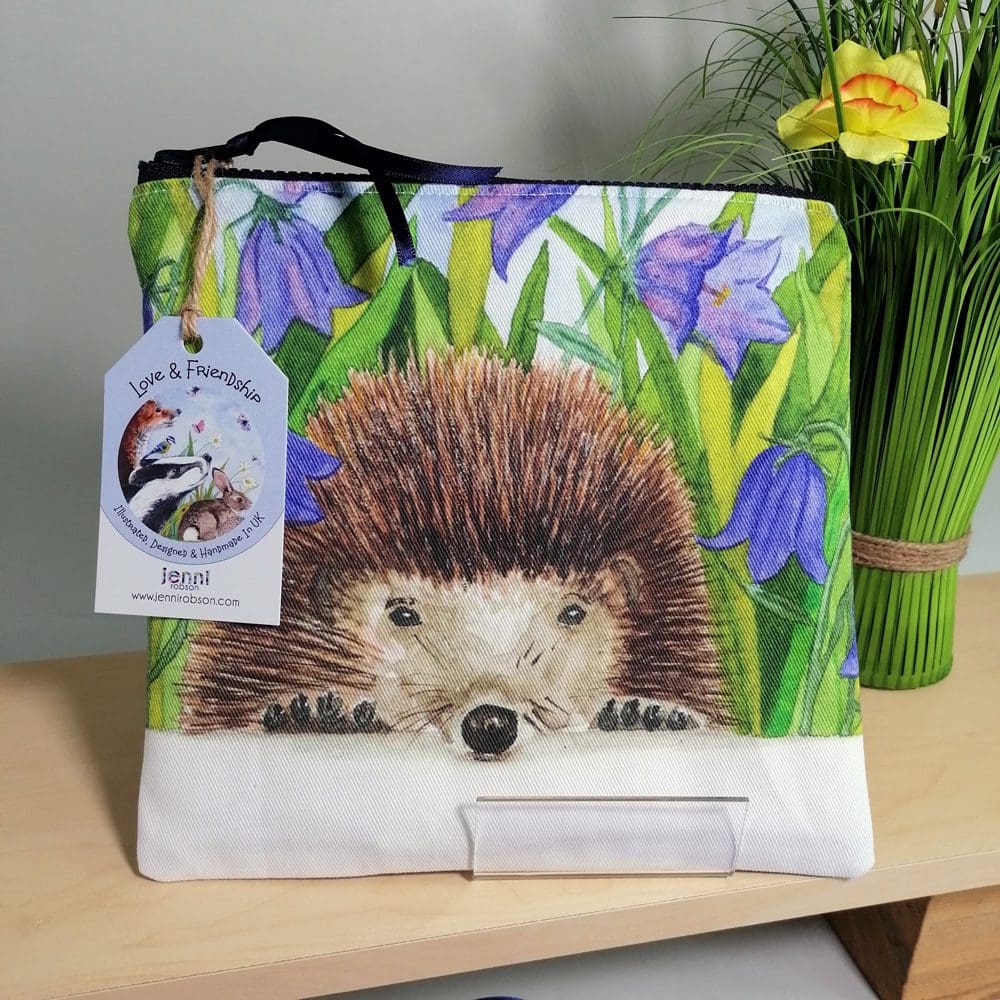 Hedgehog and harebells toiletries bag with light purple back, water resistant lining, chunky zipper fastening and internal pocket. Pencil case, make-up bag, cosmetic purse, travel bag