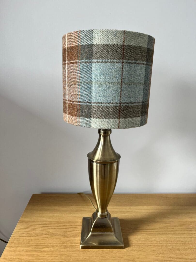 20cm drum lampshade in a pale blue and brown tartan wool fabric.