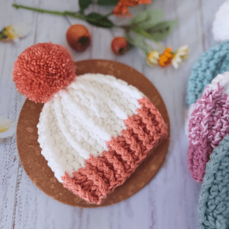 Chunky pom pom beanie bobble hat made with 2 strands of double knit yarn with a matching yarn pom pom,. They are made in sizes newborn up to large adult - perfect for all the family