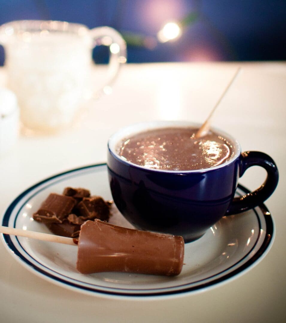 hot chocolate stick with a mug of hot milk