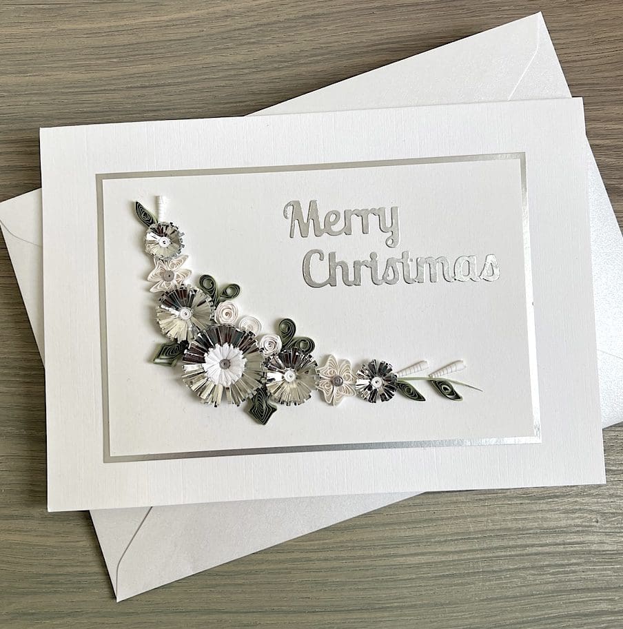 Handmade Christmas card with quilled flowers and foliage