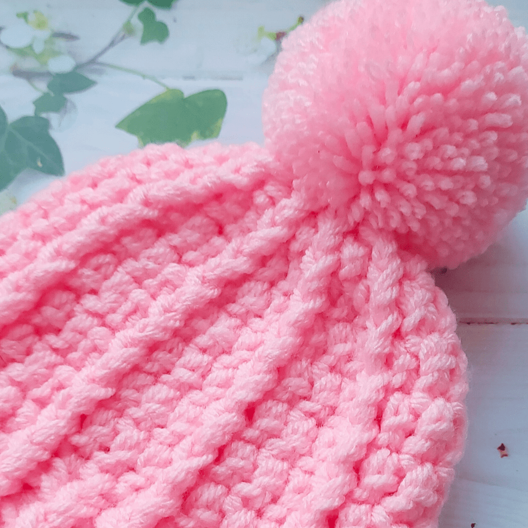Chunky pink pom pom bobble hat in size 0-3 months
