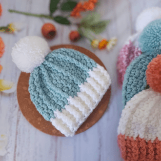 Two tone chunky handmade pom pom beanie bobble hat. Made with 2 strands of acrylic double knit yarn and a handmade matching pom pom