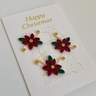 Handmade Christmas card with three red quilled poinsettias and gold "Happy Christmas"