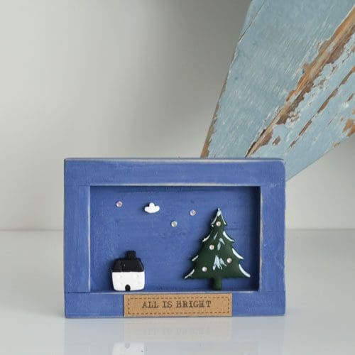 Handmade miniature wooden frame with clay festive scene