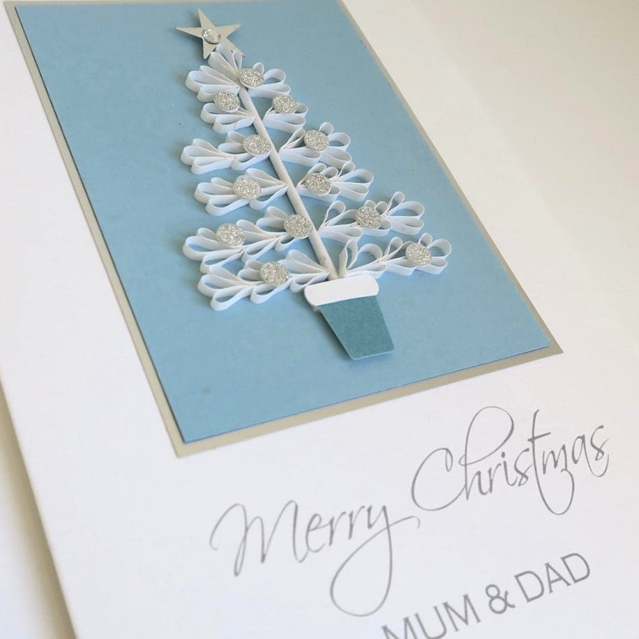 Handmade Christmas card in blue white and silver with a quilled tree