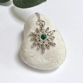 Handmade silver snowflake necklace with emerald green cubic zirconia gemstone