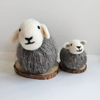 Small and large needle felted herwick sheep on wood slice