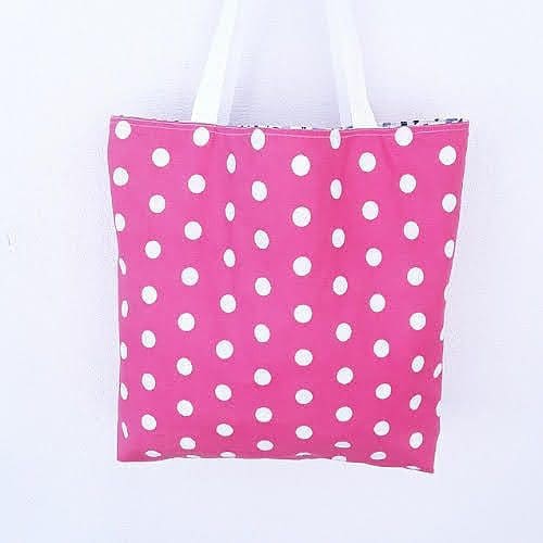 Tote bag, reversible, showing white spots on pink