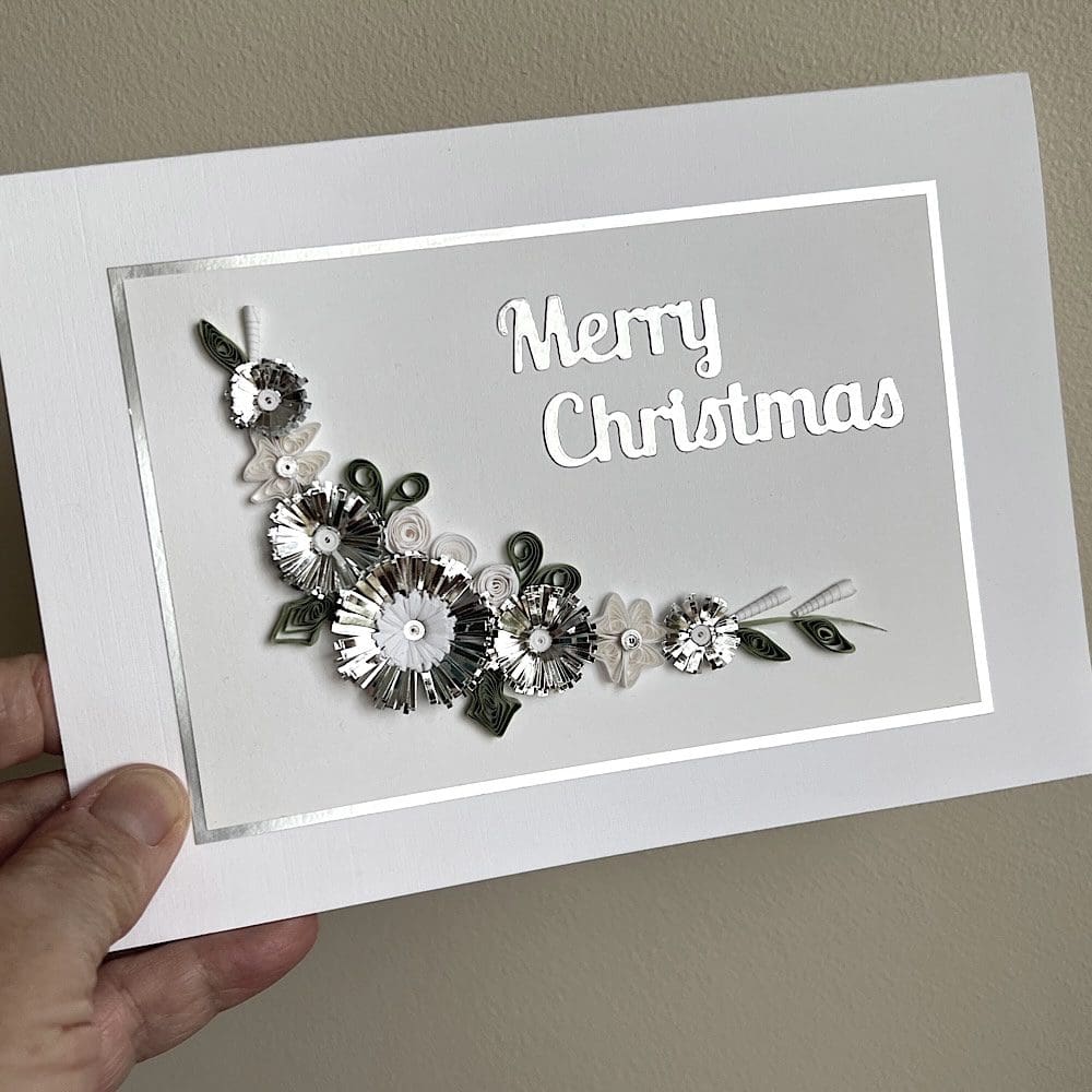 Handmade Christmas card with quilled flowers and foliage
