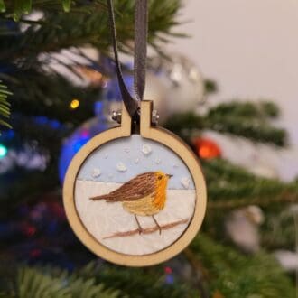 Hand embroidered robin in the snow 4cm mini hoop Christmas tree decoration.