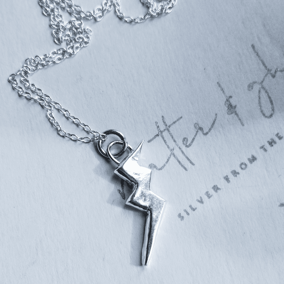Silver lightning bolt pendant on necklace