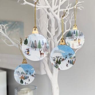 4 Christmas tree baubles with a ski slope scene using reverse decoupage on acrylic. 8cm in diameter finished with gold leaf tops and a gold elasticated hanger