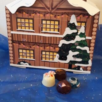 Advent Calendar in a chalet form with four chocolate truffles shown