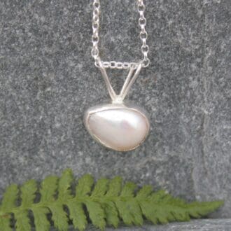 Pearl in silver necklace