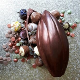 A chocolate cocoa pod filled with truffles, shapes and buttons
