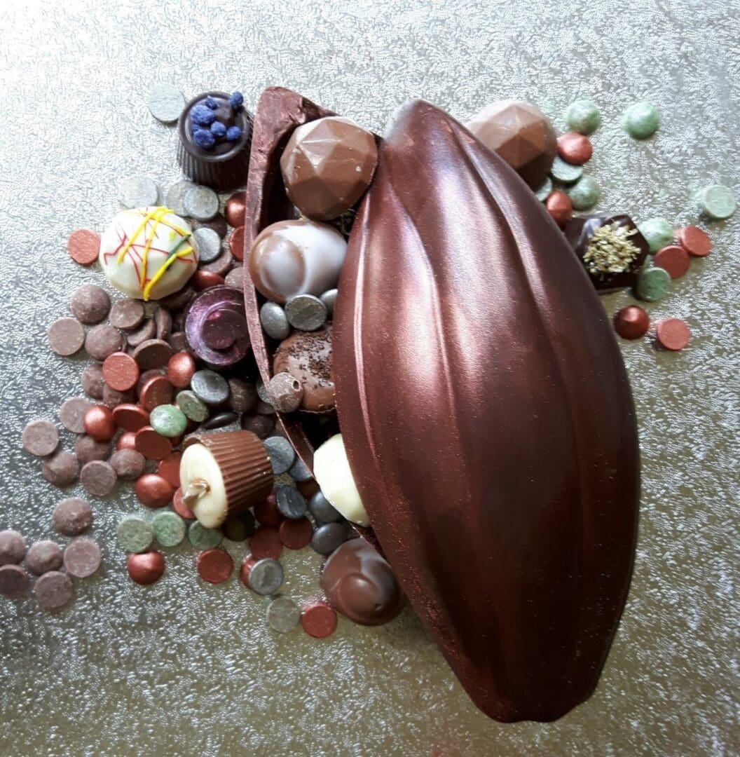 A chocolate cocoa pod filled with truffles, shapes and buttons